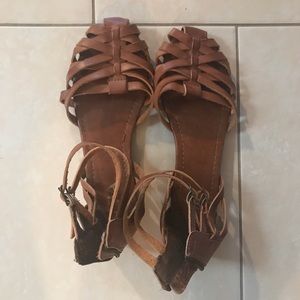 Flat brown sandals with back zip. Size 7.